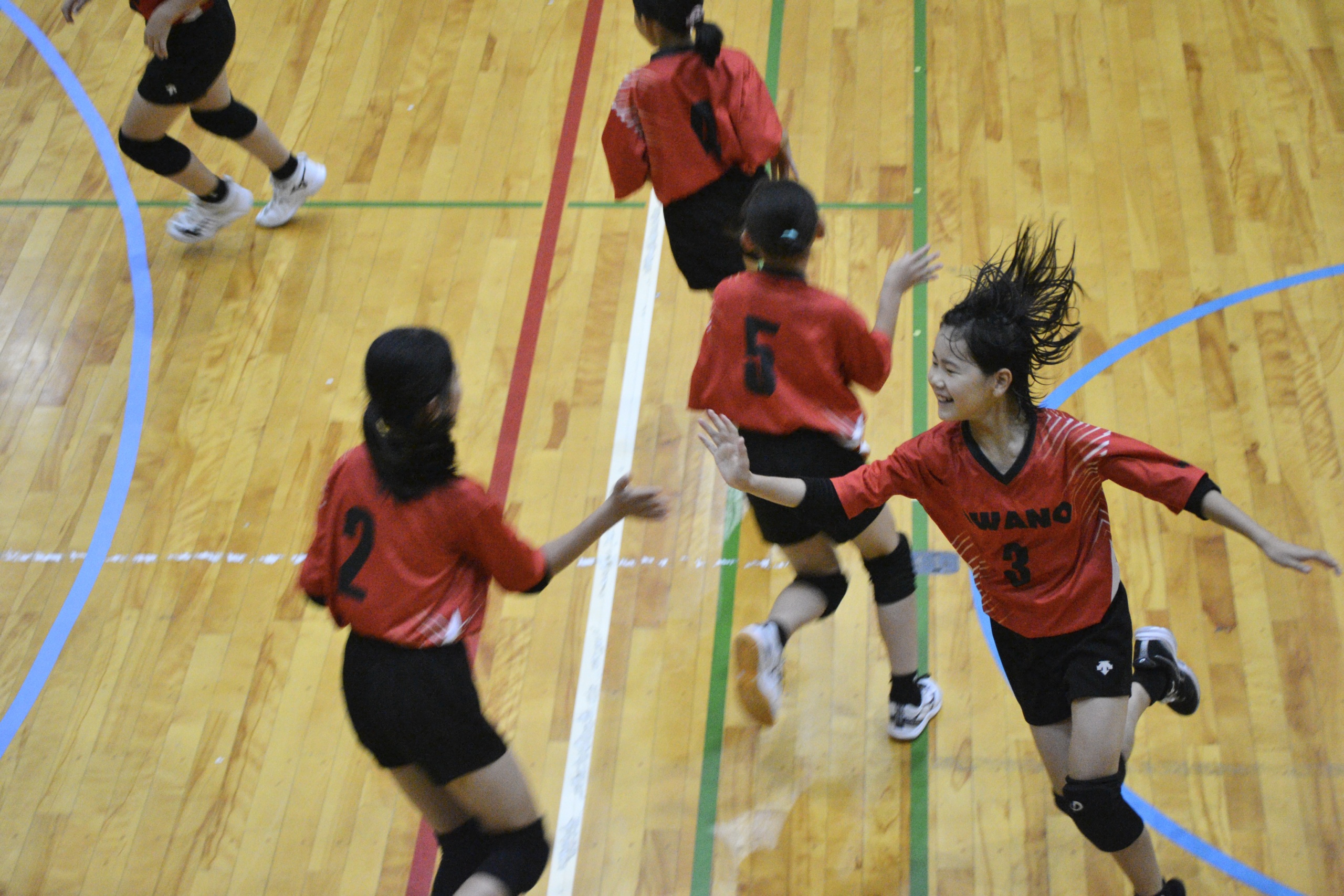 越前市大会で得点を喜びハイタッチする粟野女子チーム